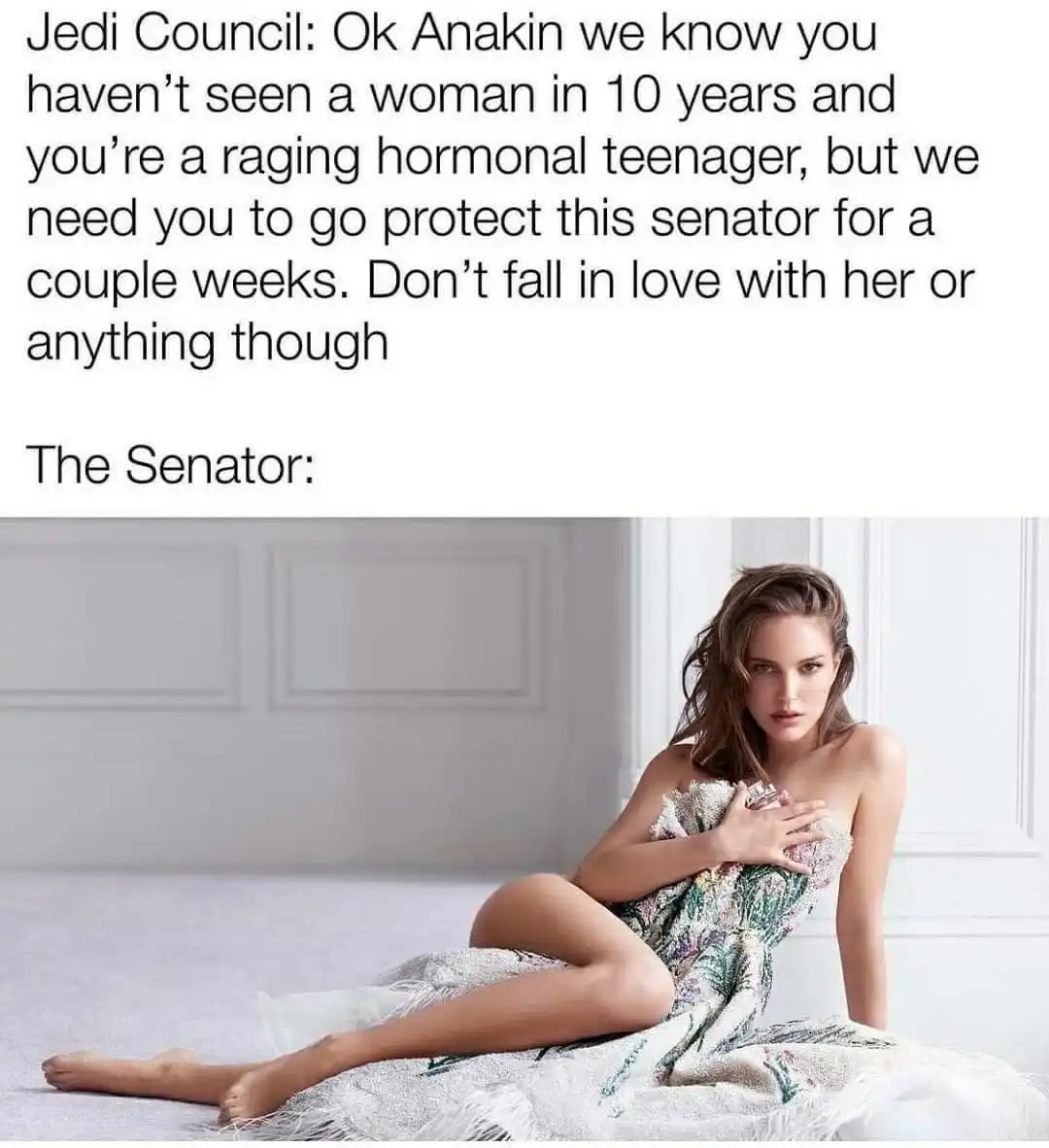 A woman with brown hair, wearing a floral-patterned dress, sits on a light-colored carpeted floor against a white paneled…