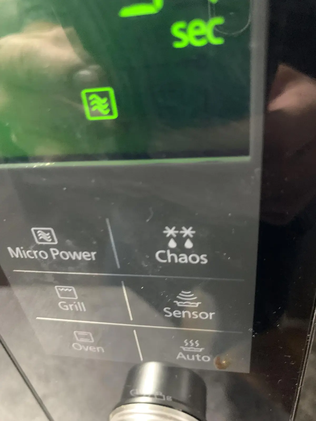 A close-up of a microwave's control panel showing buttons labeled 'Micro Power', 'Chaos', 'Grill', 'Sensor', 'Oven', and…