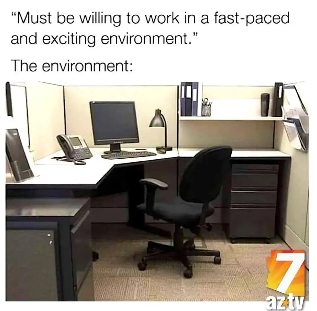 An image of a typical, quiet, beige office cubicle with a desk, computer monitor, keyboard, phone, lamp, and filing cabinet…