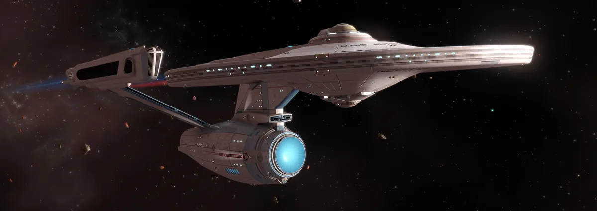 A detailed image of the U.S.S. Enterprise starship from Star Trek, shown in space with stars and asteroids in the…