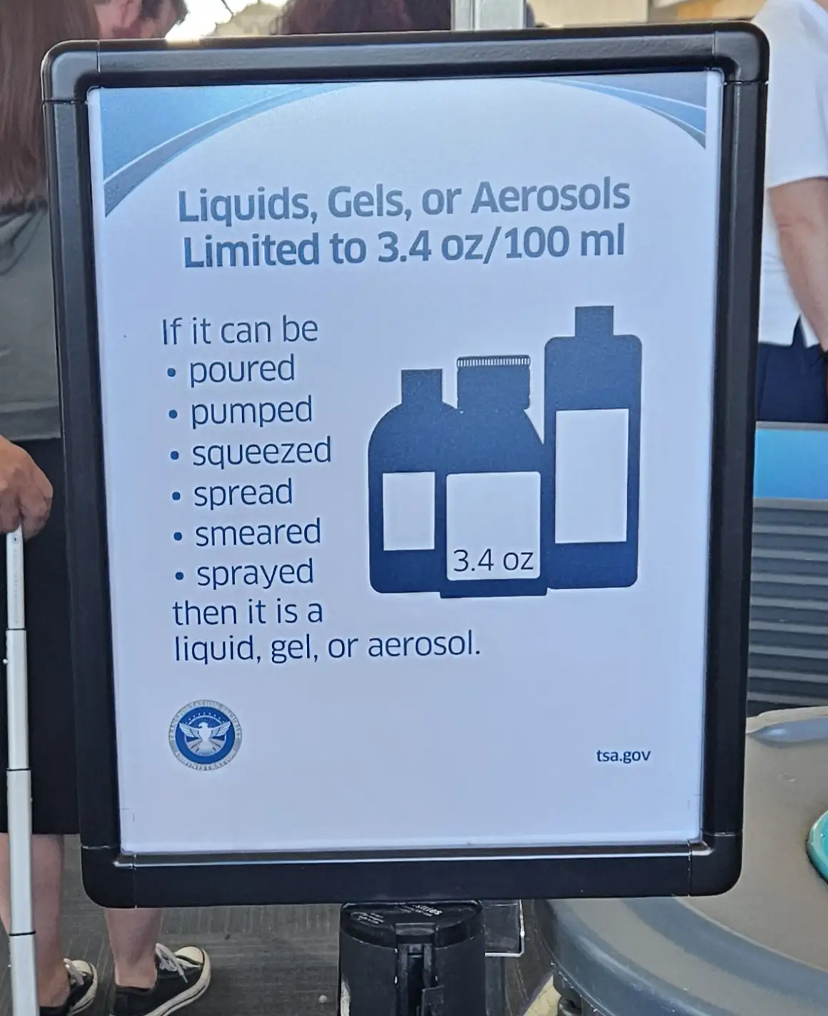 A public sign from the Transportation Security Administration (TSA) at an airport security checkpoint, displaying rules for…