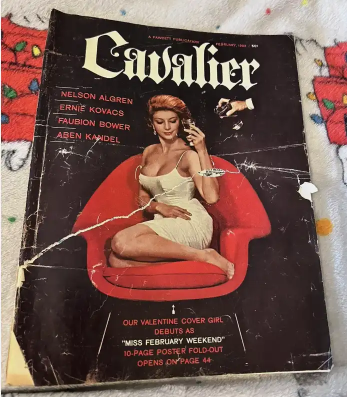 A vintage February 1959 issue of 'Cavalier' magazine shows a woman in a white dress sitting in a red chair, holding a glass…