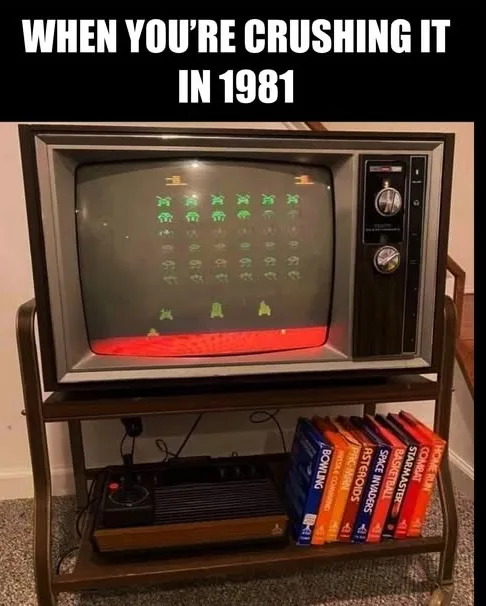 An old CRT television displaying the arcade game Space Invaders, with a red laser beam shooting down rows of green aliens…