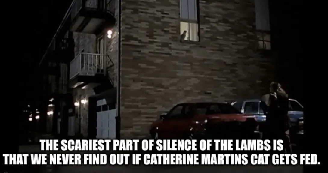 A still from the movie 'Silence of the Lambs' shows a dark apartment building at night with a person standing near parked…