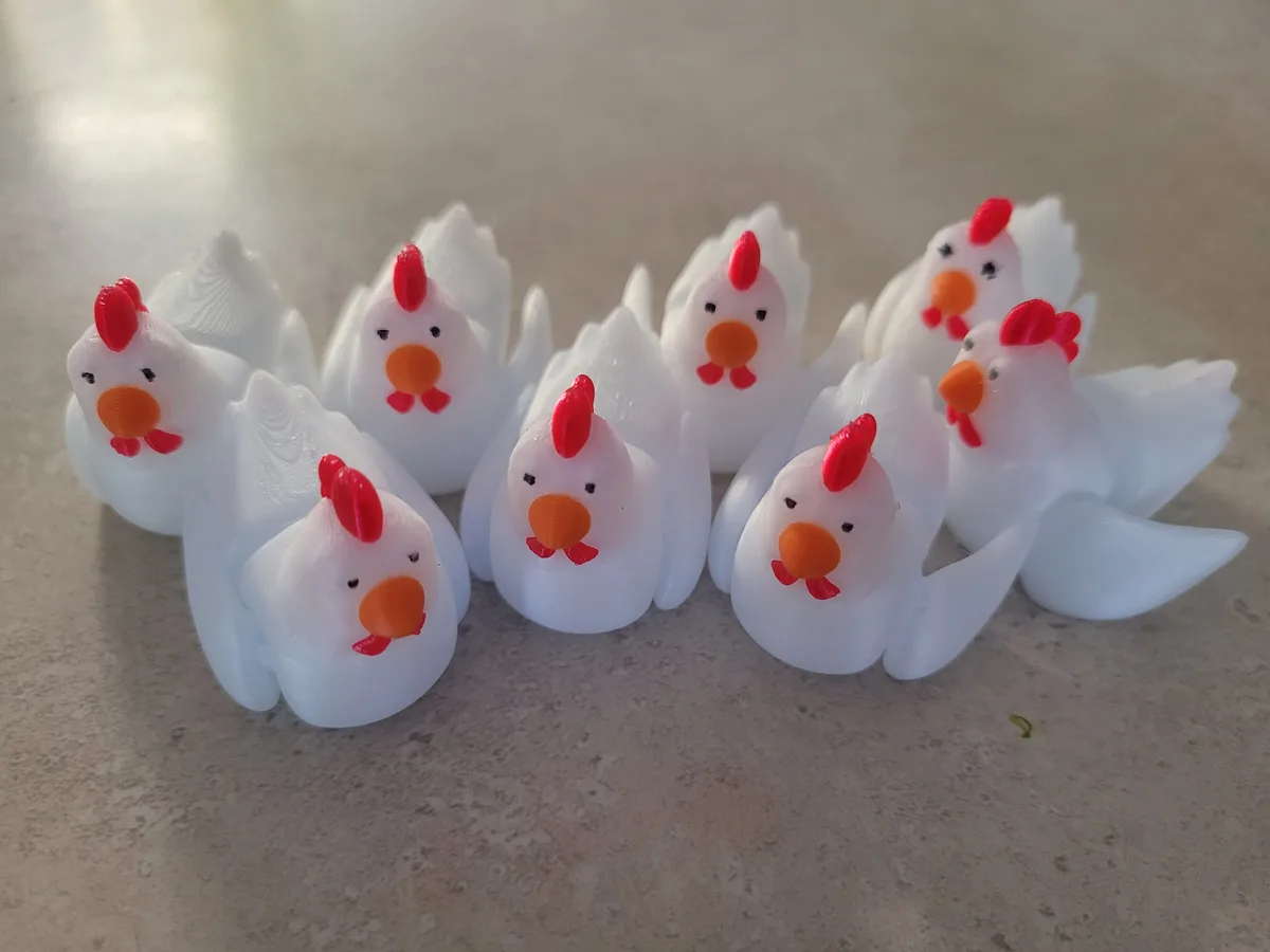 The image shows a group of identical white plastic toy chickens with red combs and wattles, orange beaks, and black eyes…