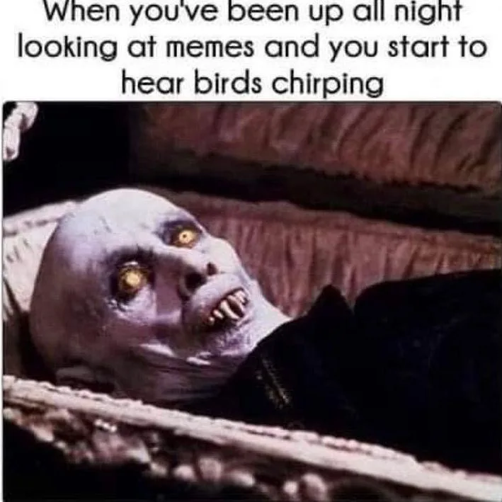 A pale, bald, undead-looking character with glowing yellow eyes and sharp teeth lies in an ornate coffin, looking startled…
