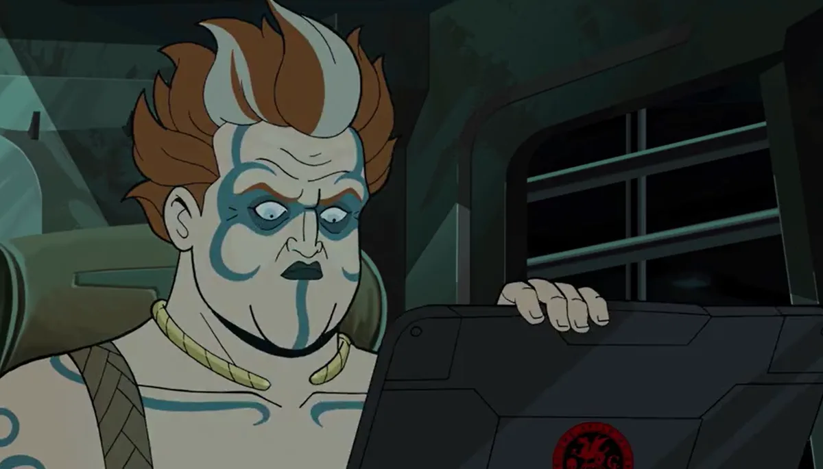 An animated character with blue face paint, spiky brown and white hair, and a stern expression is shown gripping the edge of…