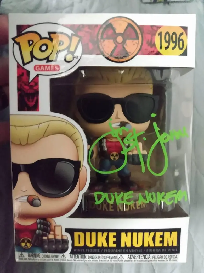 A Funko Pop! Games vinyl figure of Duke Nukem in his iconic sunglasses and red shirt, displayed in its original packaging…