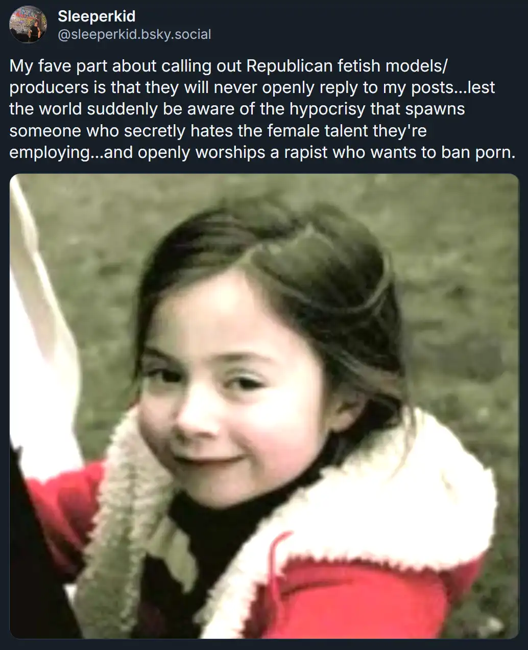 A screenshot of a social media post by 'Sleeperkid' featuring a photo of a young girl in a red jacket with a white fur…