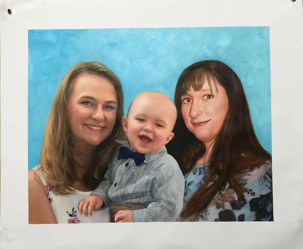 A painted portrait of two women and a baby boy against a blue background; the baby is smiling broadly while the women smile…