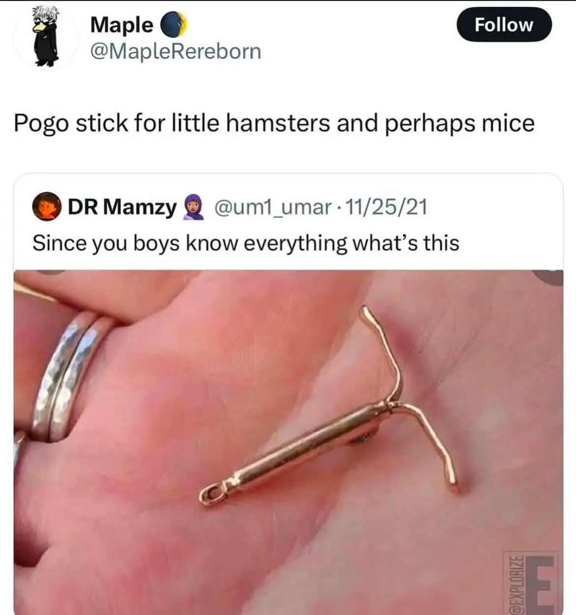 A close-up image shows a tiny, gold-colored metal object resting in the palm of a human hand, which has two silver rings on…