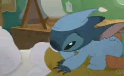 A six-frame sequence shows Stitch, a blue alien character, attempting to sleep on a bed with white pillows. He initially…
