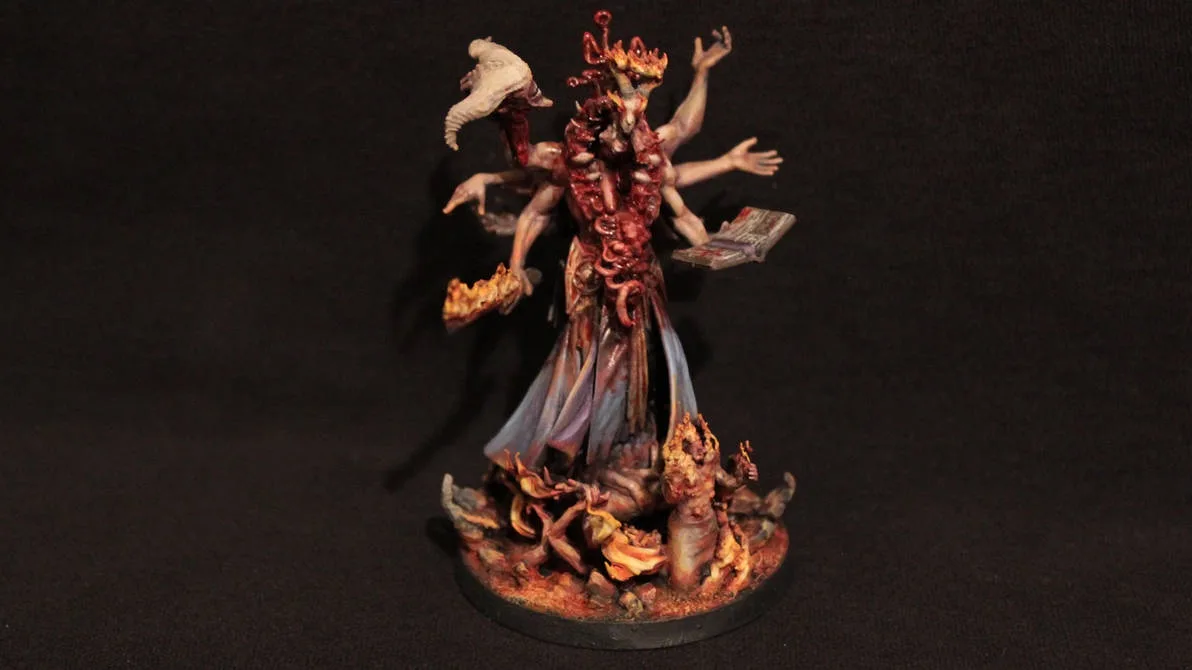 A highly detailed, grotesque miniature figurine depicts a multi-armed, demonic-looking entity with a crown, holding a book…