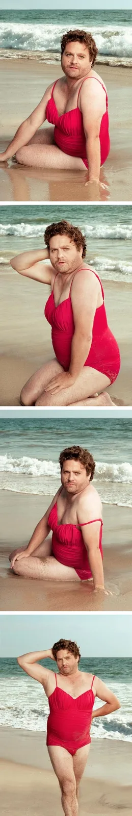 A man with curly brown hair and a beard is shown in four sequential beach photos wearing a red one-piece swimsuit. In each…