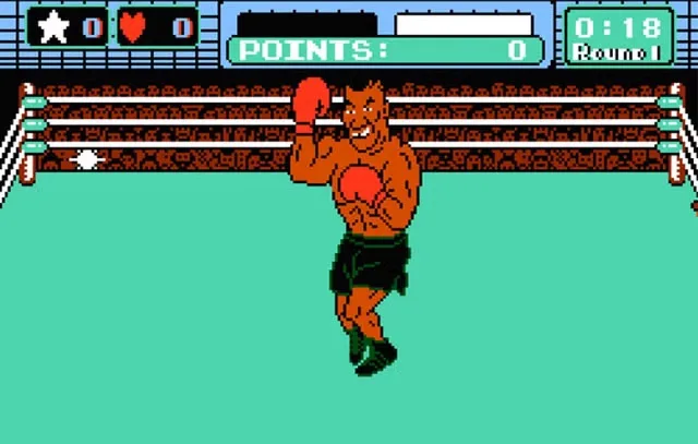 A pixelated video game boxer with red gloves and green shorts stands in a boxing ring, smiling and flexing. The game UI…