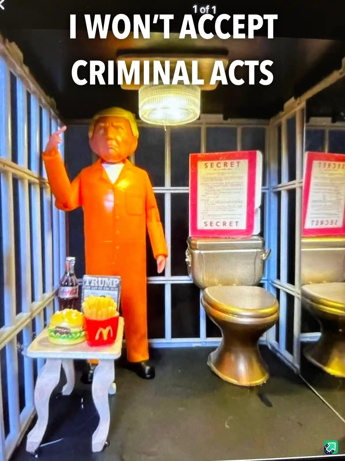 A figurine resembling Donald Trump in an orange prison jumpsuit stands inside a jail cell with metal bars, pointing upward…