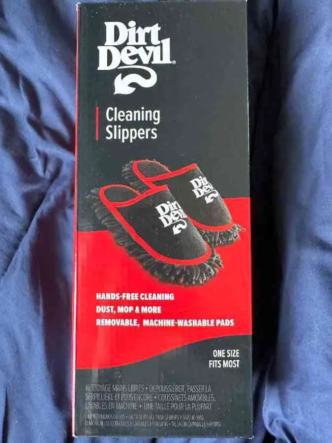 A product box for 'Dirt Devil Cleaning Slippers' shows black slipper-shaped cleaning pads with red trim and the brand logo…