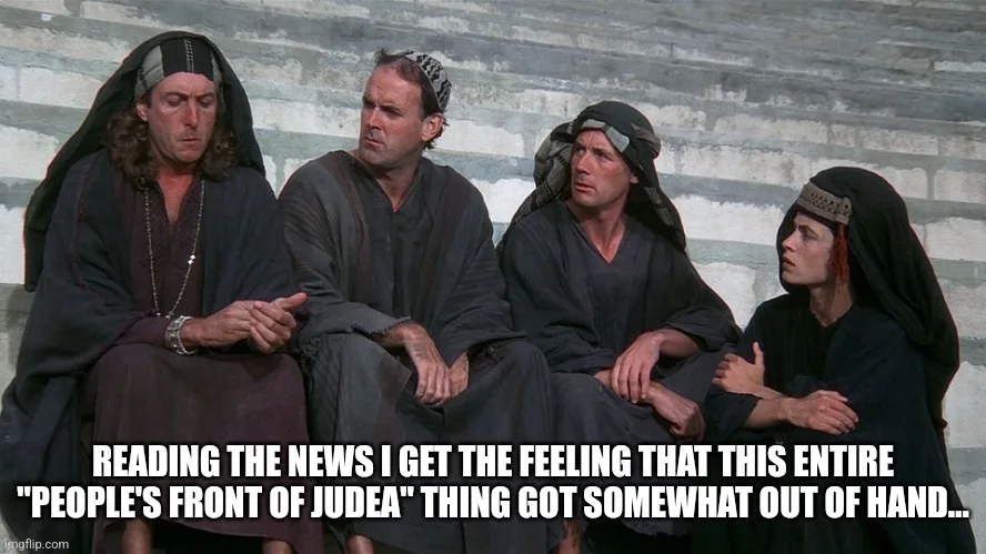 Four men in ancient robes sit on stone steps, looking concerned and weary. The text overlaid at the bottom reads: 'READING…