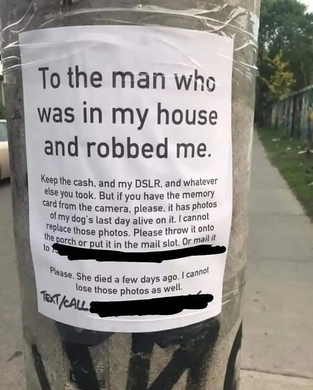 A handwritten note taped to a concrete utility pole asks a burglar to return a stolen memory card containing photos of the…
