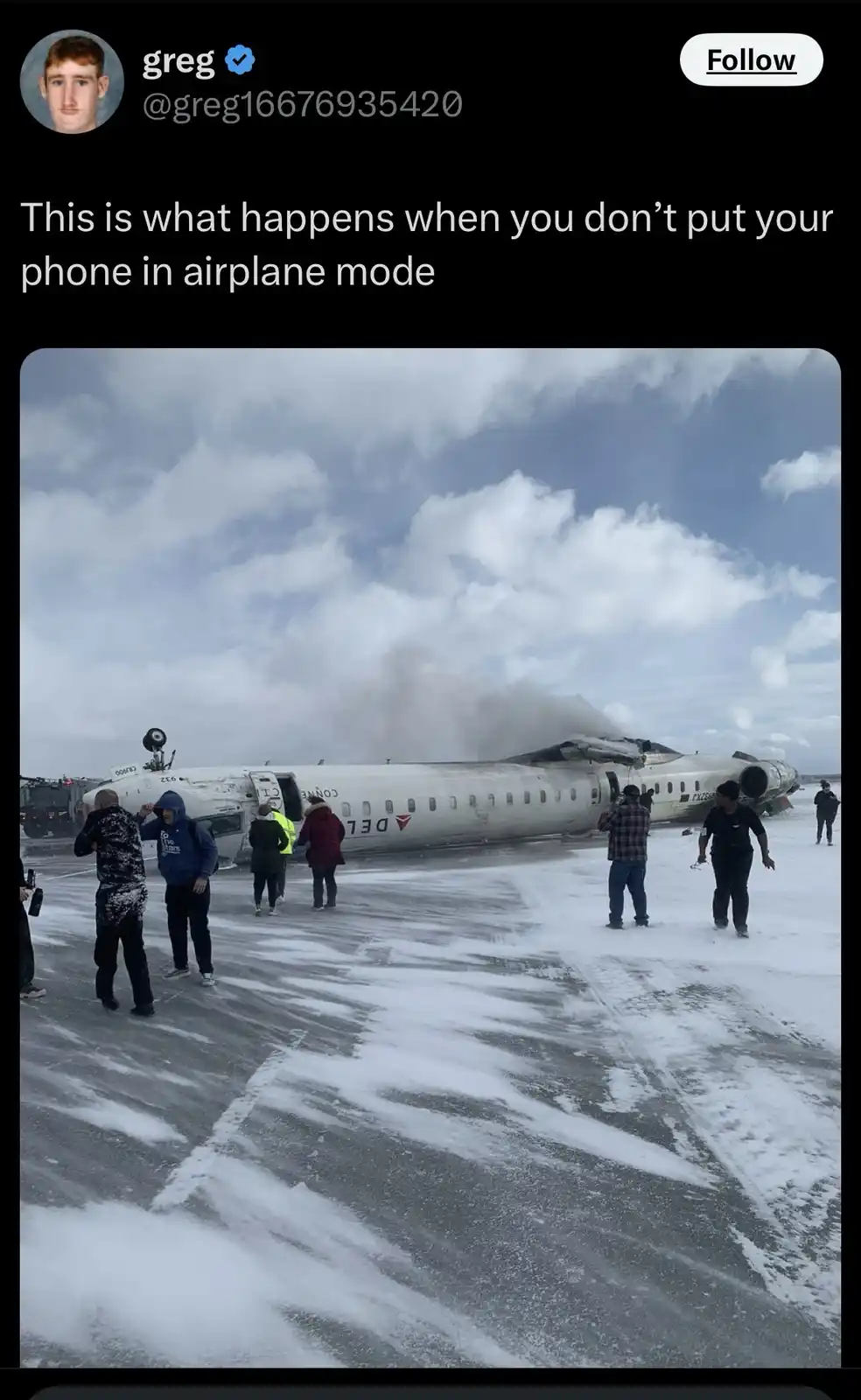 An image shows a damaged Delta airplane on a snowy tarmac with smoke coming from the rear, surrounded by people in winter…