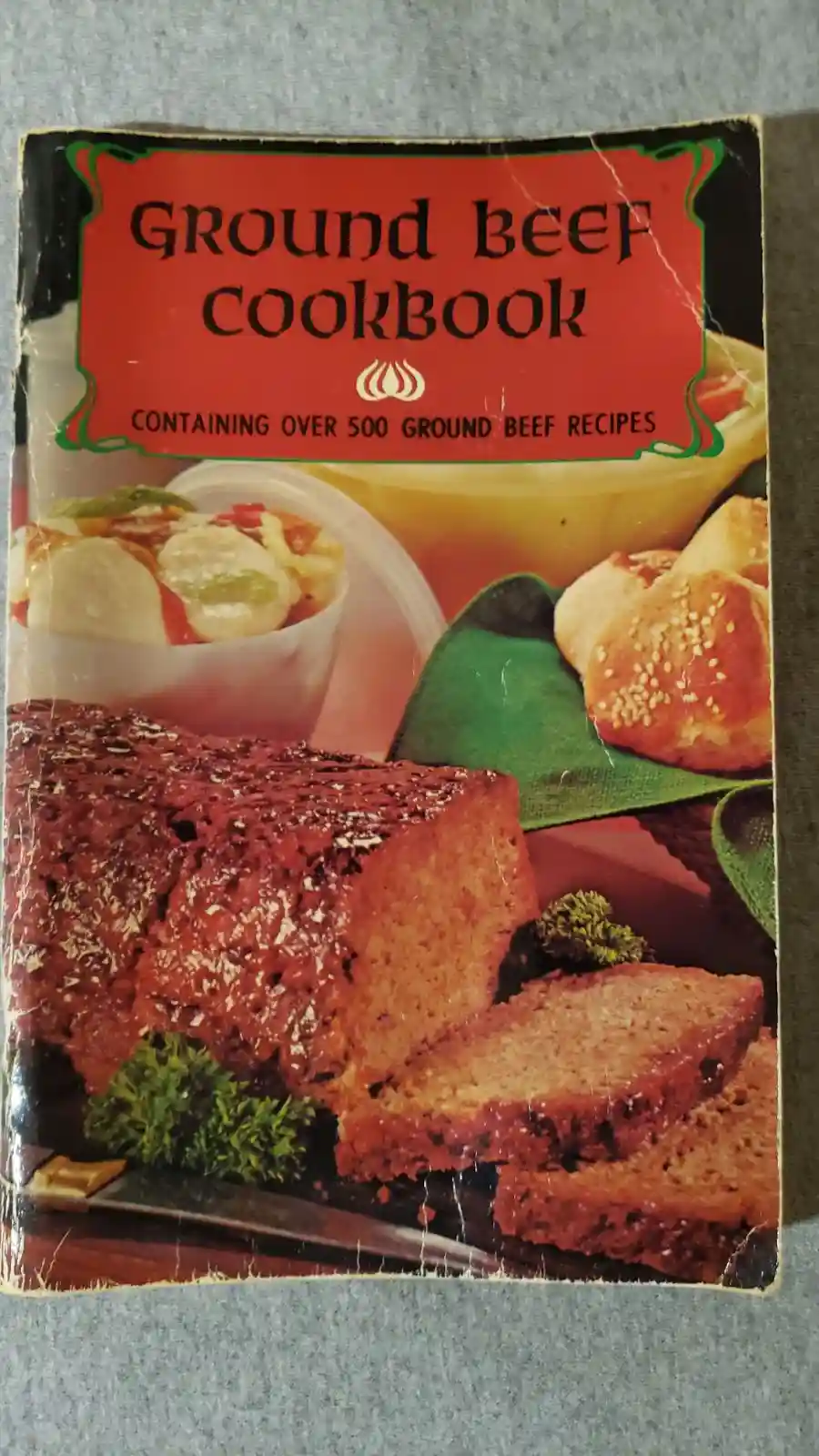The image shows a vintage cookbook cover titled 'Ground Beef Cookbook' with the subtitle 'Containing over 500 ground beef…
