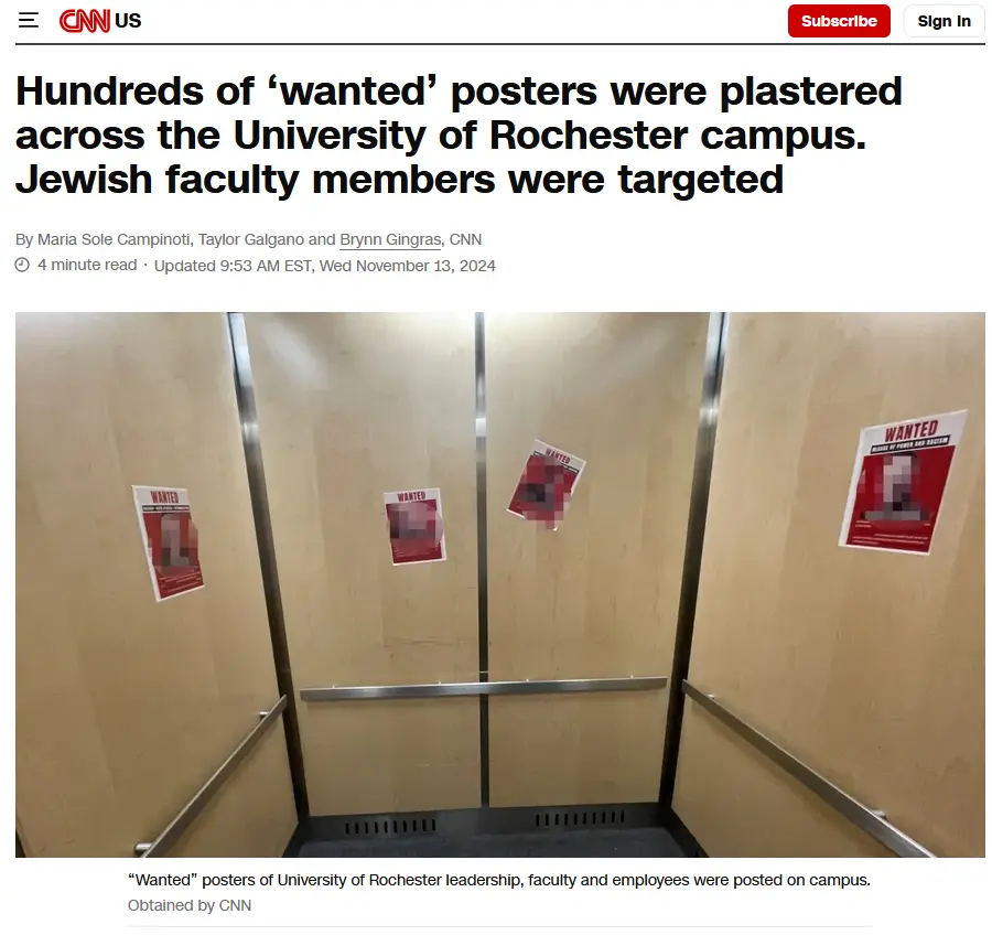 The image shows the interior of an elevator with four red and white 'WANTED' posters taped to the beige walls. Each poster…