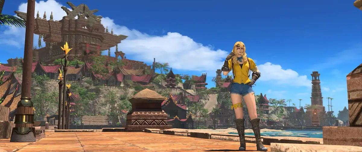 A blonde female video game character in a yellow shirt and denim shorts stands in a tropical, Southeast Asian-inspired…