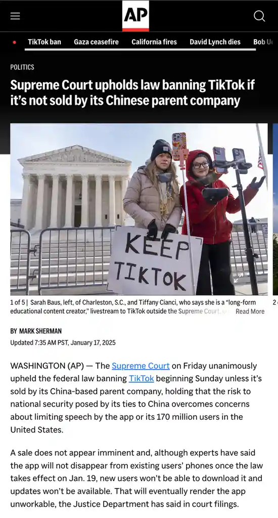 Two women stand outside the Supreme Court building holding a protest sign that reads 'KEEP TIKTOK' while livestreaming on…
