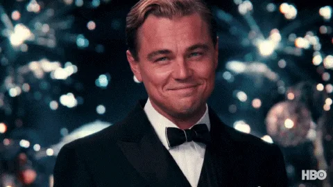 A six-panel image sequence shows Leonardo DiCaprio in a tuxedo, smiling and holding a champagne glass, with a sparkling…