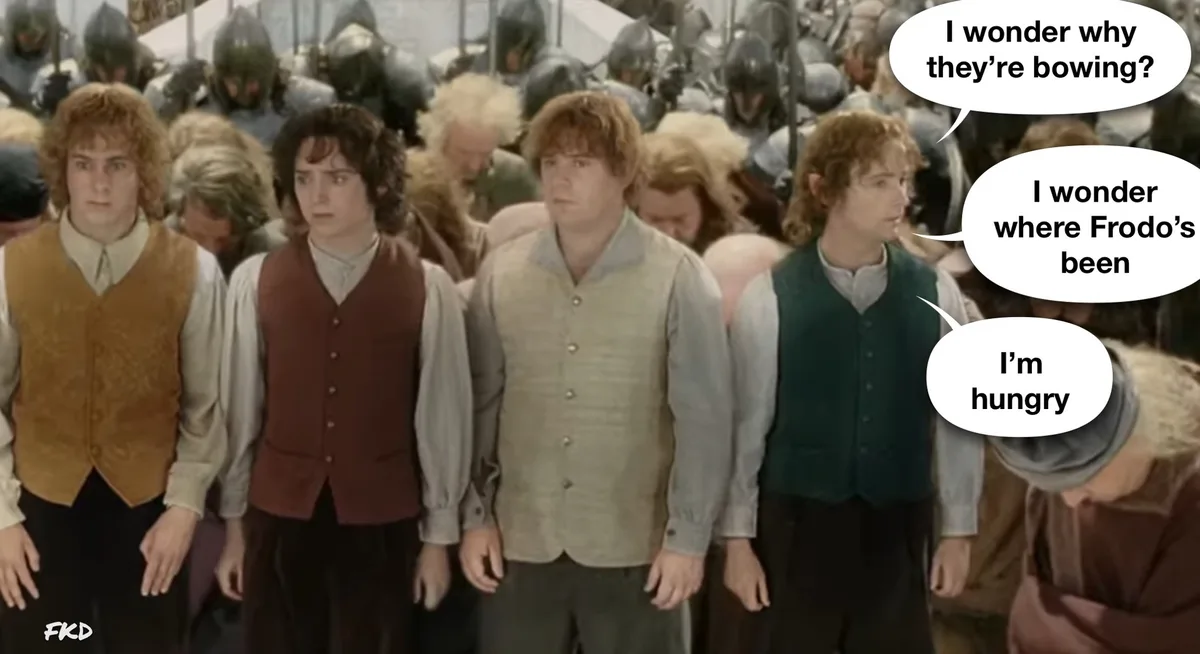 A still from 'The Lord of the Rings' shows a group of hobbits standing in a line, most bowing while a few stand upright…