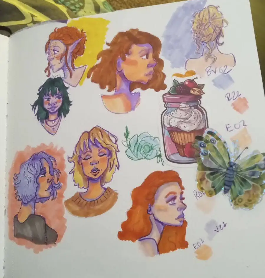A sketchbook page filled with colorful watercolor drawings of various female character busts with different hair colors and…