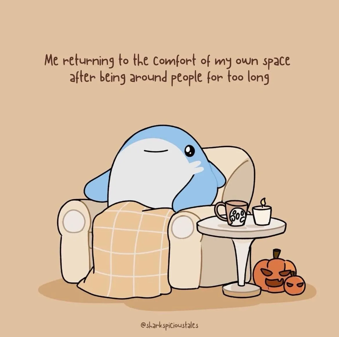 A cartoon blue and white shark is lounging in a beige armchair draped with a plaid blanket, looking relaxed with eyes…
