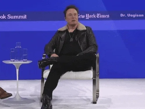 A six-panel image sequence shows Elon Musk seated in a chair at a New York Times event, progressively becoming more animated…