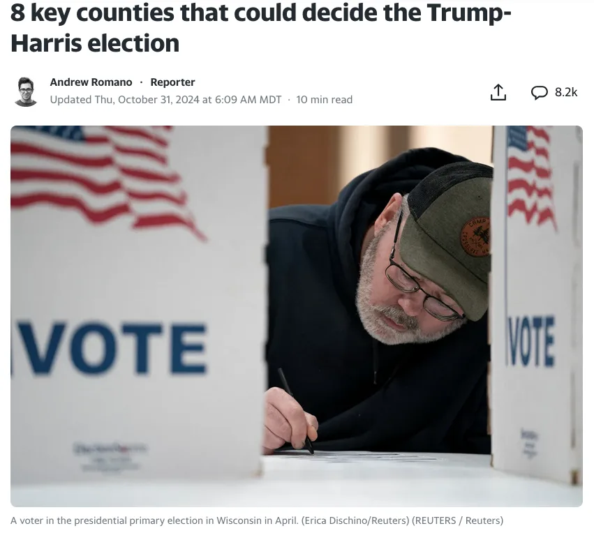 A man with glasses and a cap is seen voting at a polling station, framed by two white voting booths with 'VOTE' printed on…