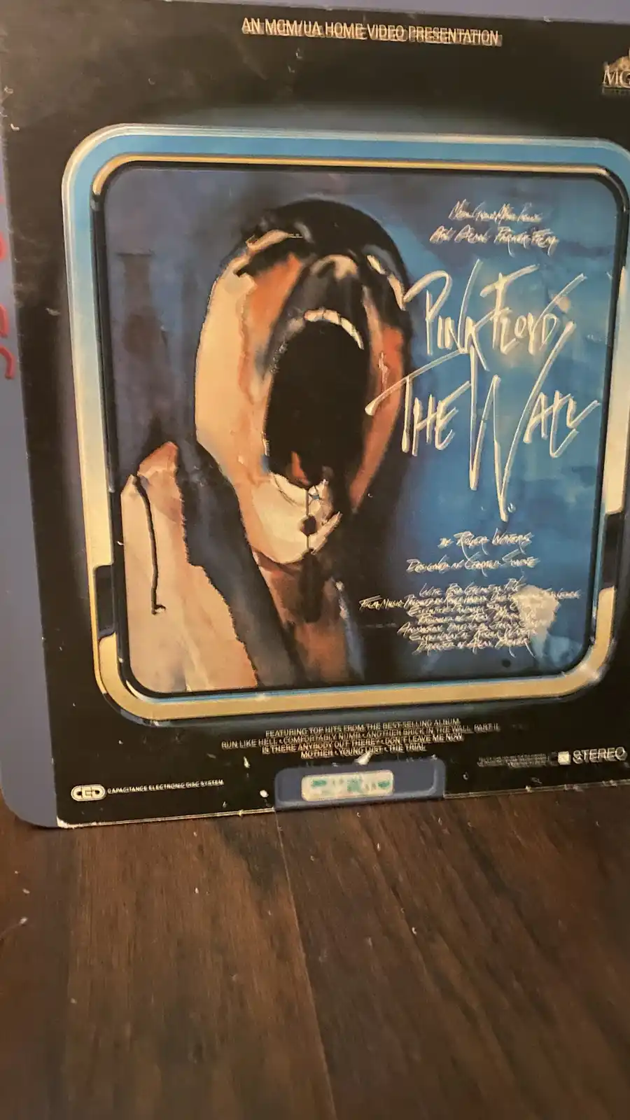 The image shows the cover of a Pink Floyd 'The Wall' CED (Capacitance Electronic Disc) home video presentation. The artwork…