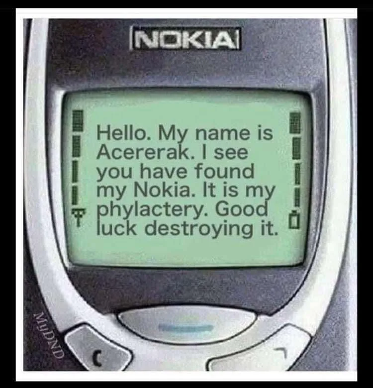 A close-up image of an old Nokia phone displaying a message that reads 'Hello. My name is Acererak. I see you have found my…