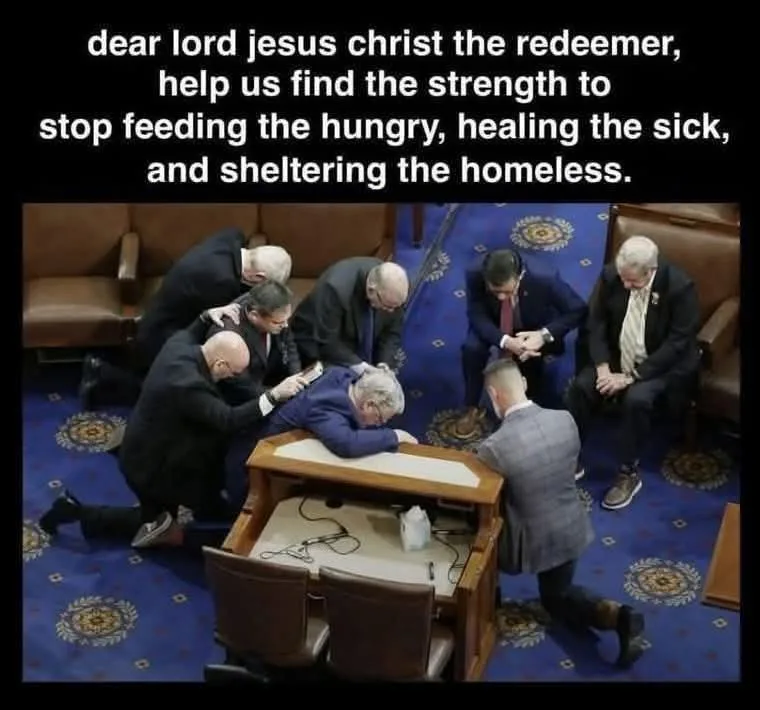 A group of men in suits kneel around a wooden podium in what appears to be a legislative chamber, with one man resting his…