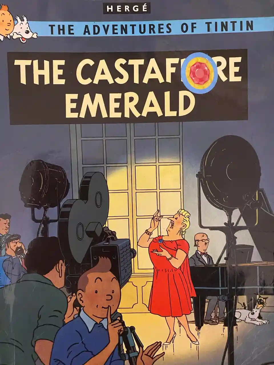 This is the cover of 'The Adventures of Tintin: The Castafiore Emerald' by Hergé, featuring Tintin in a blue shirt holding a…
