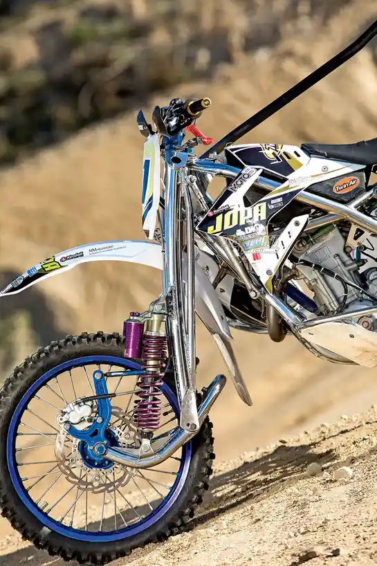 Innovative leading link front suspension for sidecar motocross bikes.