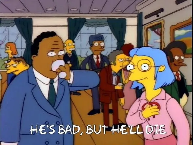 In a crowded room from The Simpsons, a man in a blue suit drinks from a glass while a woman with blue hair and glasses looks…