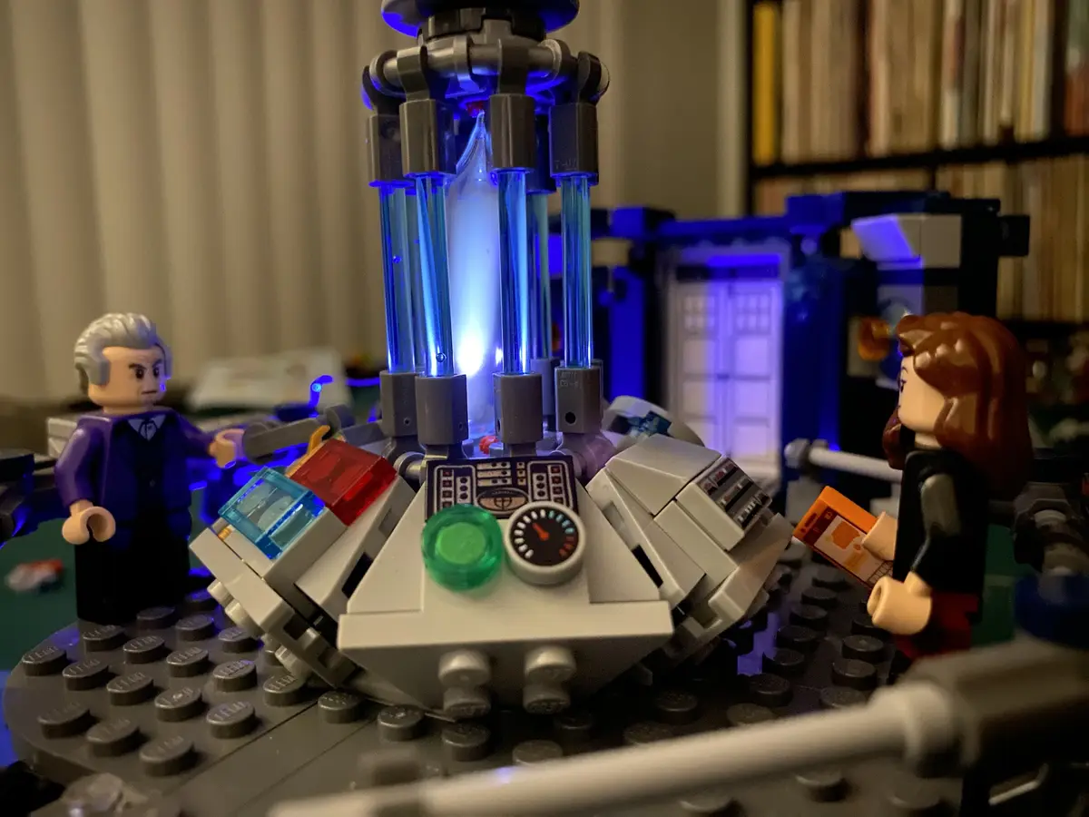 A LEGO recreation of the Doctor Who TARDIS console room, featuring two LEGO minifigures resembling the Doctor and Rose Tyler…