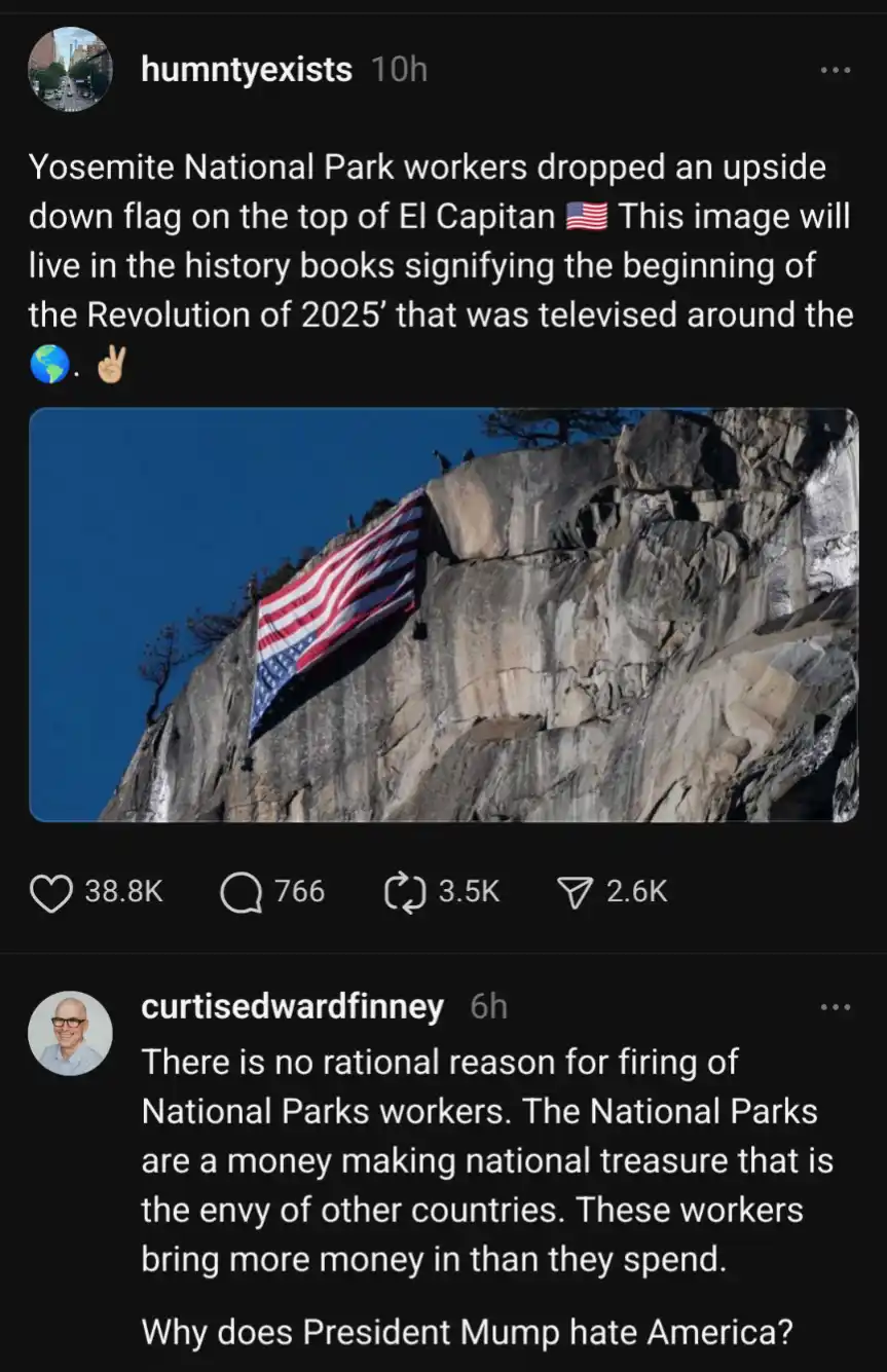 An upside-down American flag is visibly attached to the sheer granite face of El Capitan in Yosemite National Park, with a…