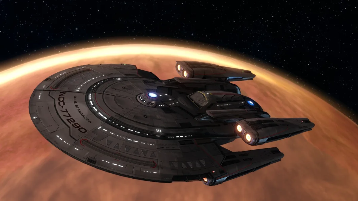 A gray Starfleet starship, labeled 'U.S.S. STARGAZER' and 'NCC-77290', flies in front of a large orange planet against a…