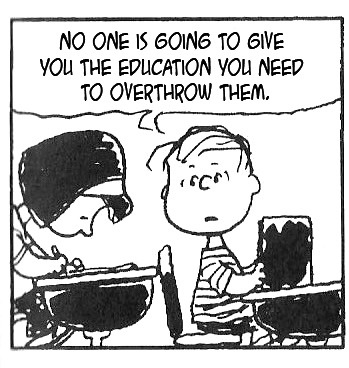 A black-and-white Peanuts comic strip panel shows Lucy van Pelt leaning over a desk, speaking to Charlie Brown who sits…