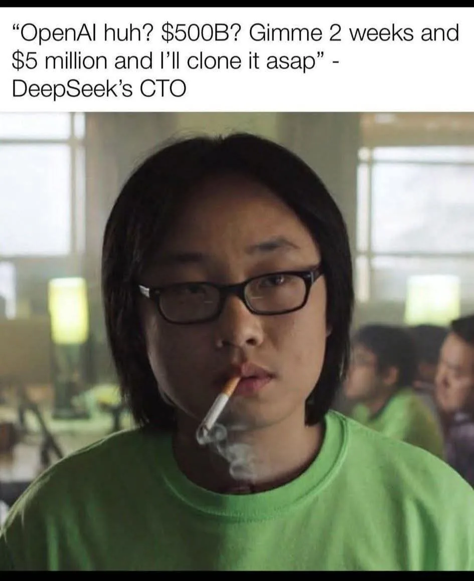 A person with dark hair and glasses, wearing a green t-shirt, smokes a cigarette while looking directly at the camera. The…