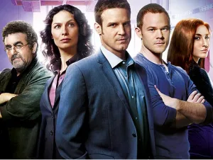 a promotional poster of the tv show 'fringe' featuring five main characters standing in a row with serious expressions. From…