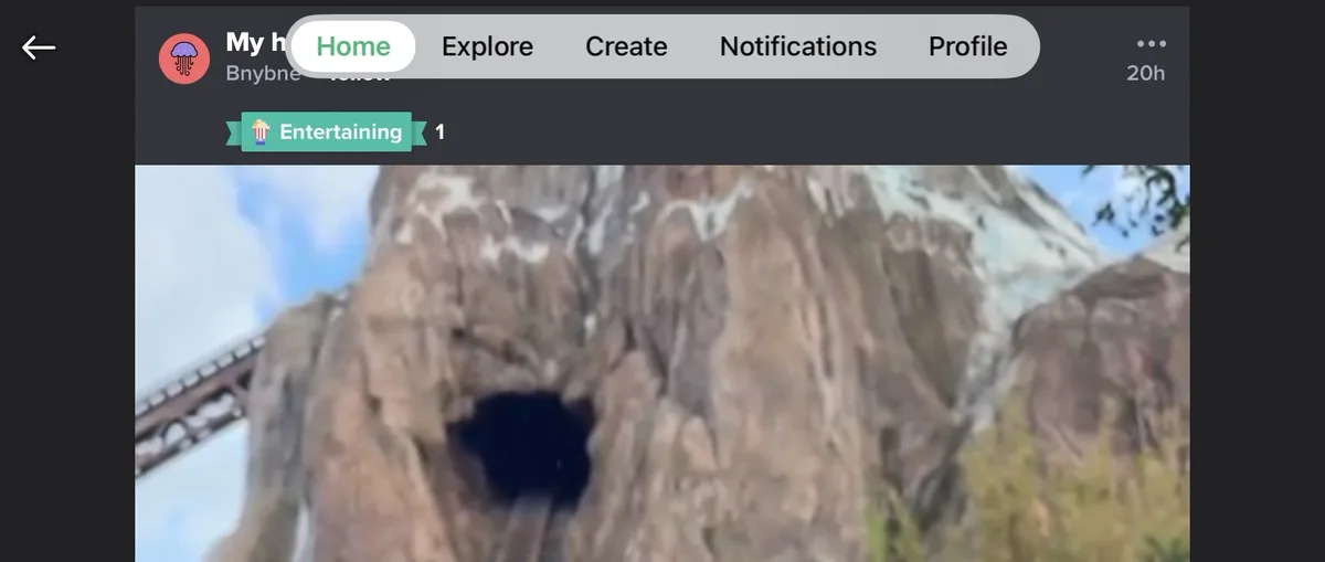 A screenshot of a social media app interface shows a video thumbnail of a roller coaster track going through a rocky…