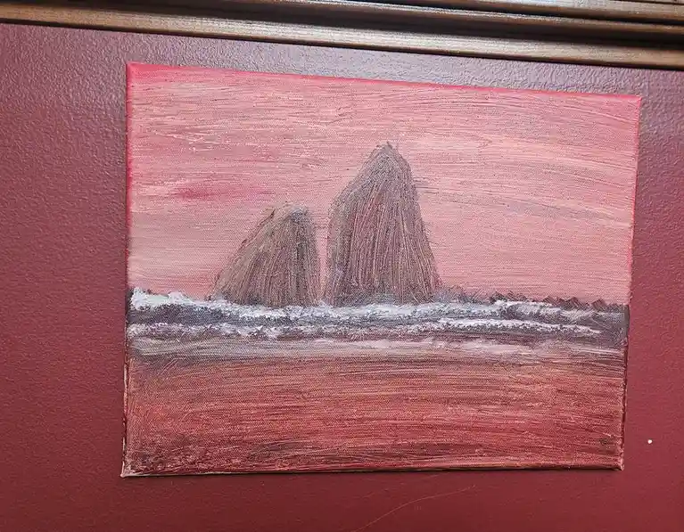 A small, textured oil painting depicts two large, dark rock formations rising from a choppy sea under a pinkish-red sky. The…