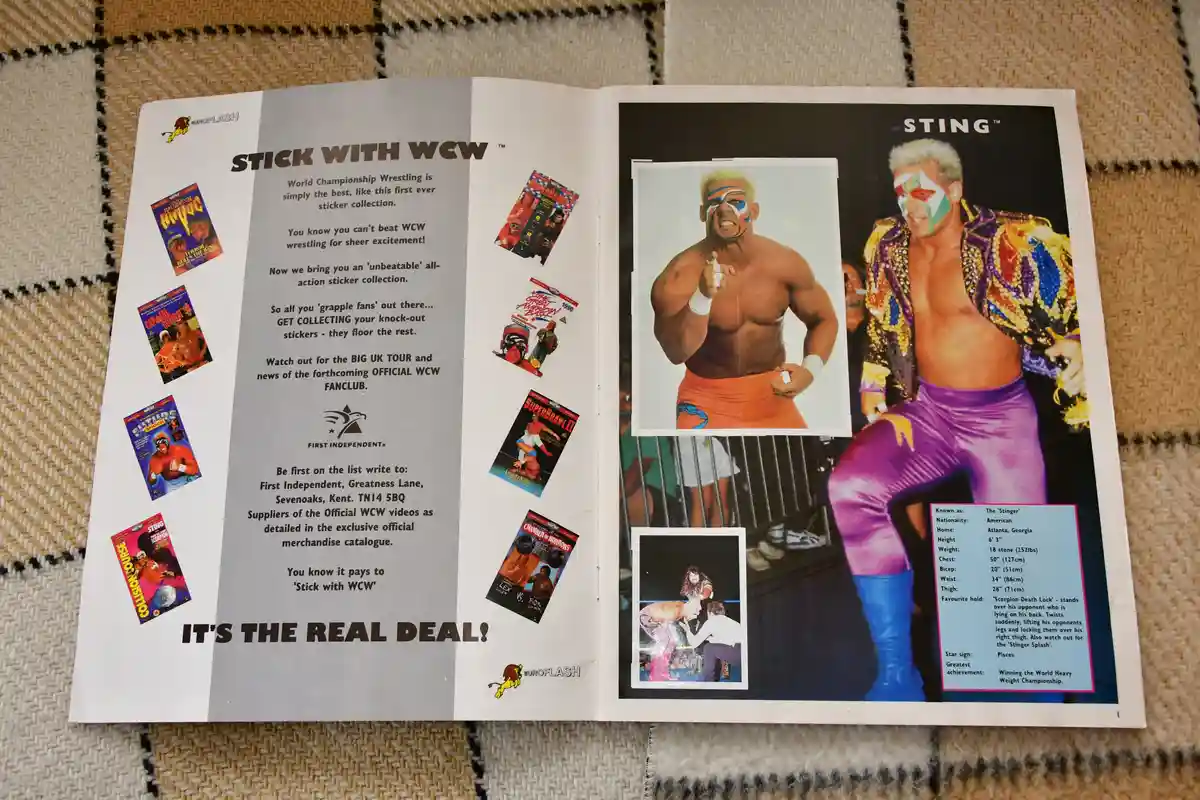 An open WCW promotional booklet features wrestler Sting in multiple photos, including one with his iconic face paint and…