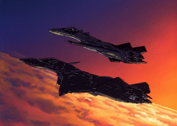 Two sleek, black fighter jets fly in formation against a vibrant sunset sky with orange and purple hues. The image is a…